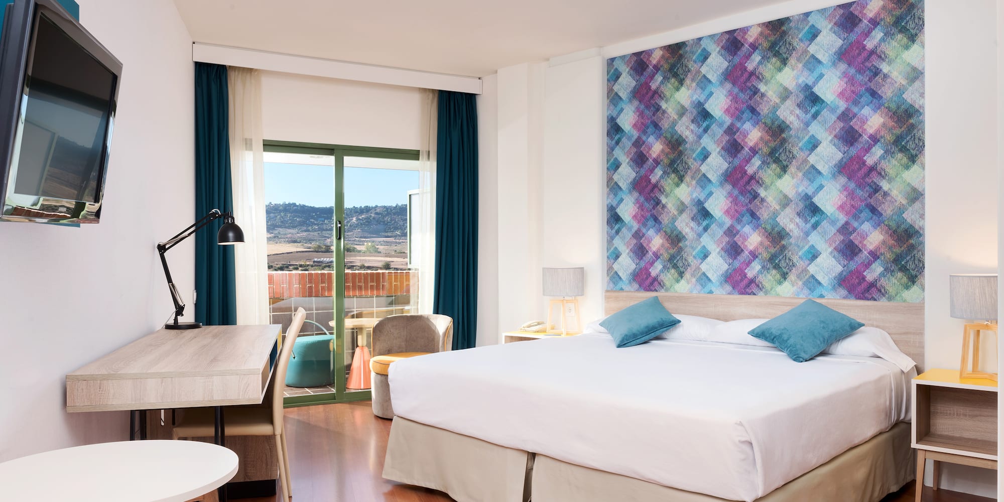 a room with a bed and a table and chairs