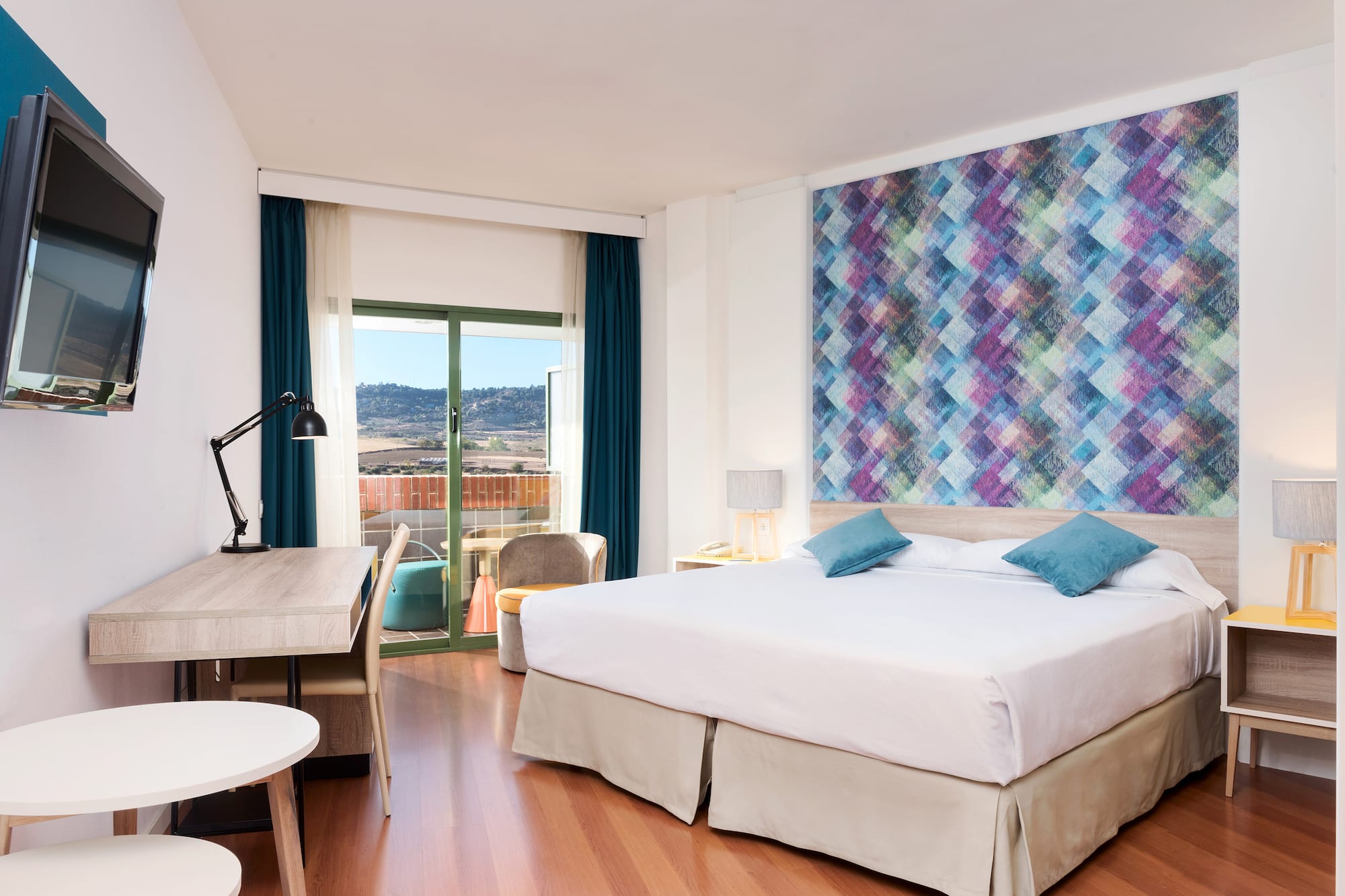 a room with a bed and a table and chairs