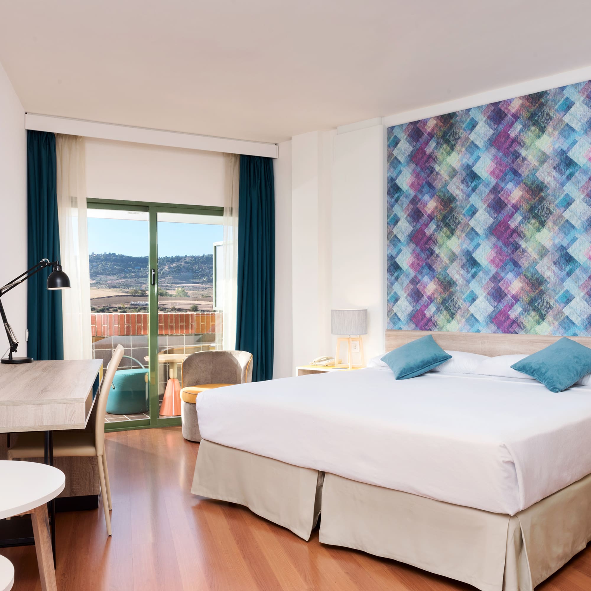 a room with a bed and a table and chairs