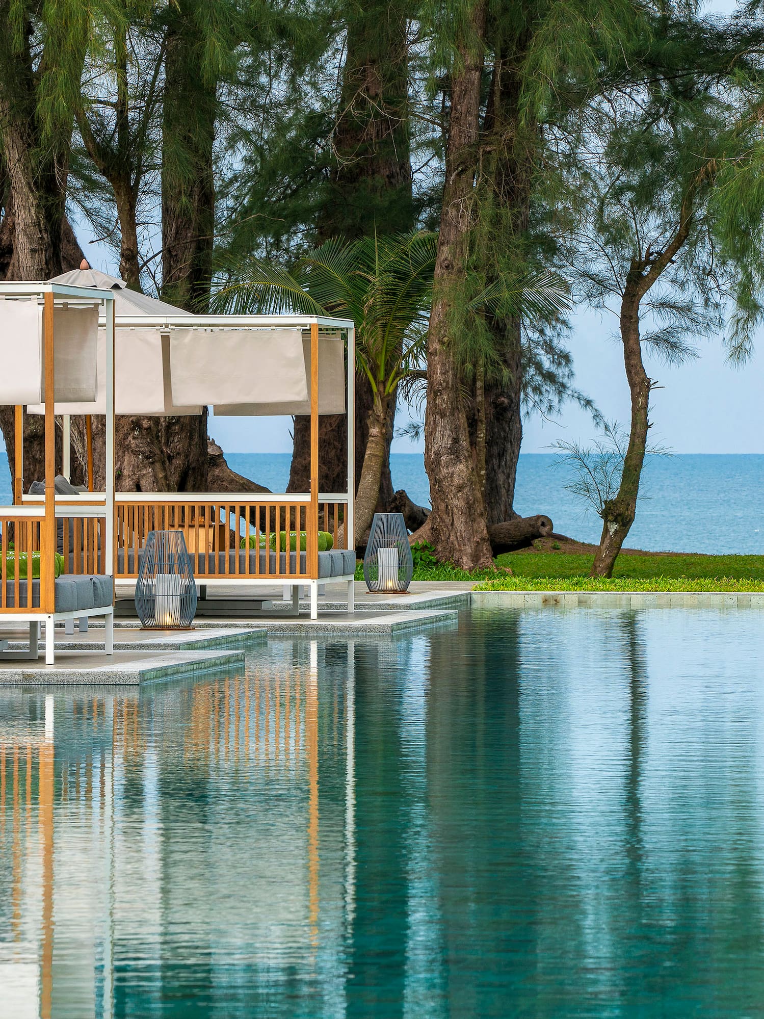 a pool with trees and a gazebo