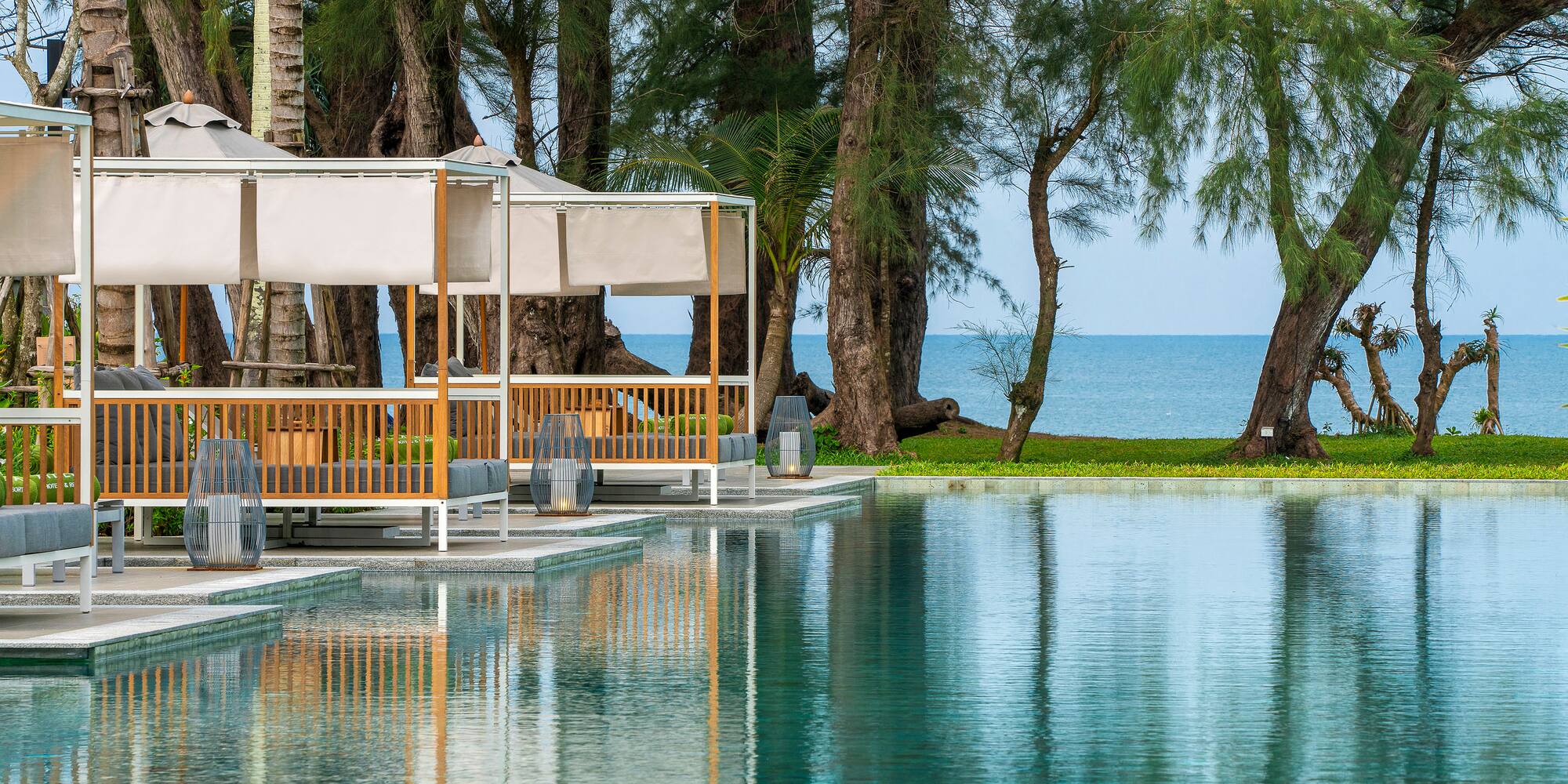 a pool with trees and a gazebo