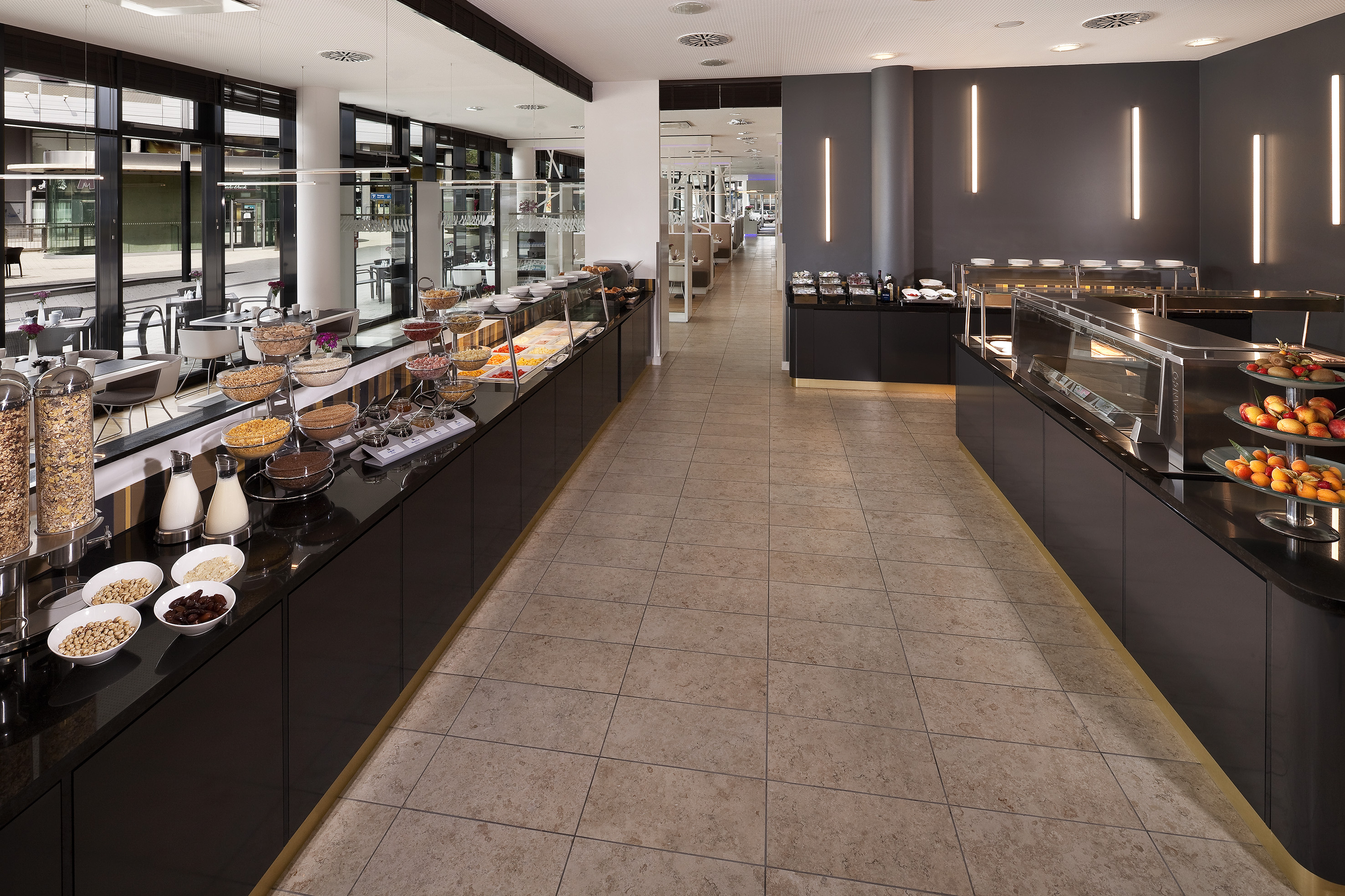 Contemporary hotel breakfast buffet, cereals, fresh fruit, hot dishes.