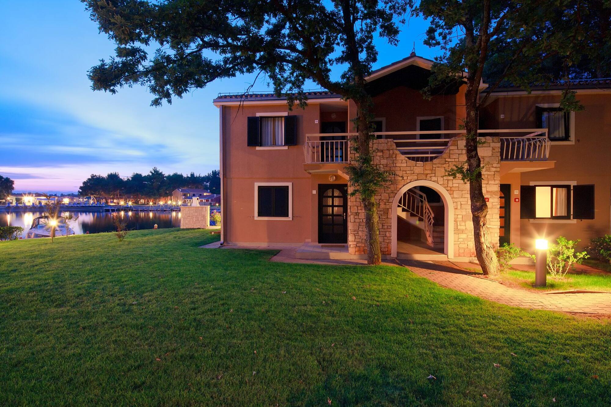 a house with a walkway and trees