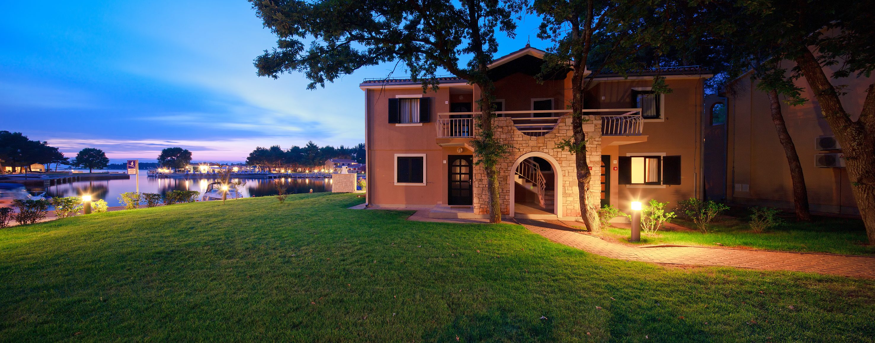 a house with a walkway and trees