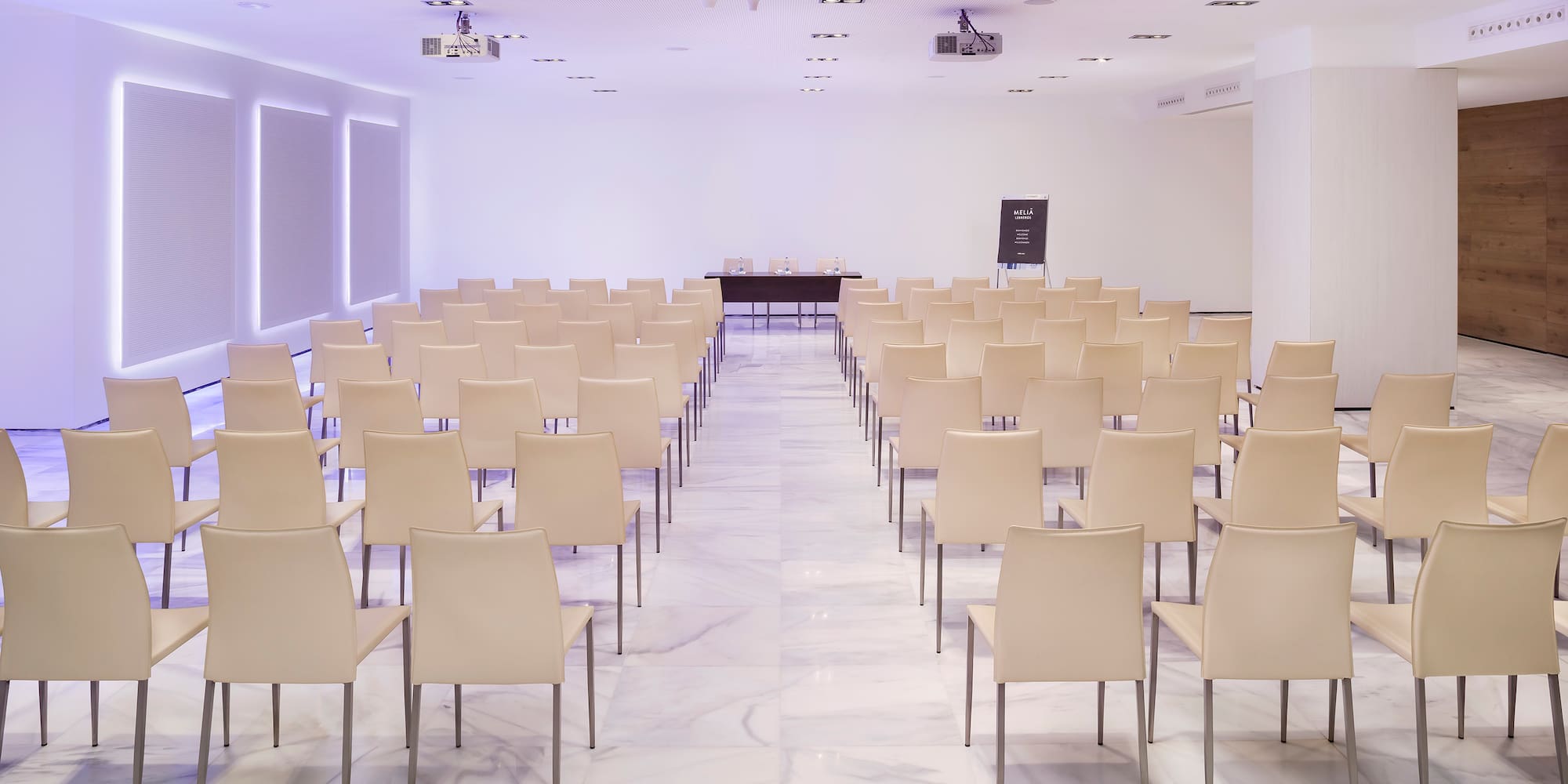 a room with white chairs