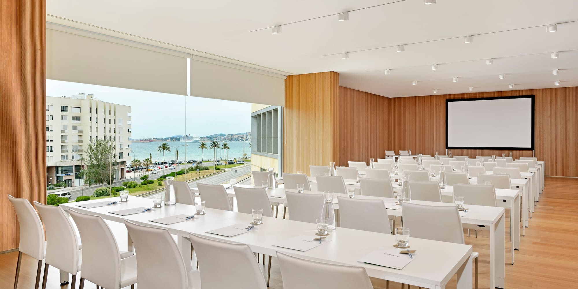a room with white tables and chairs