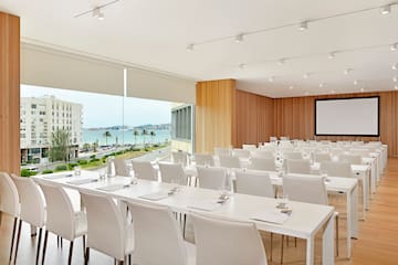 a room with white tables and chairs