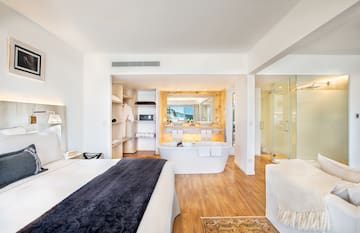 a room with a large bed and bathtub