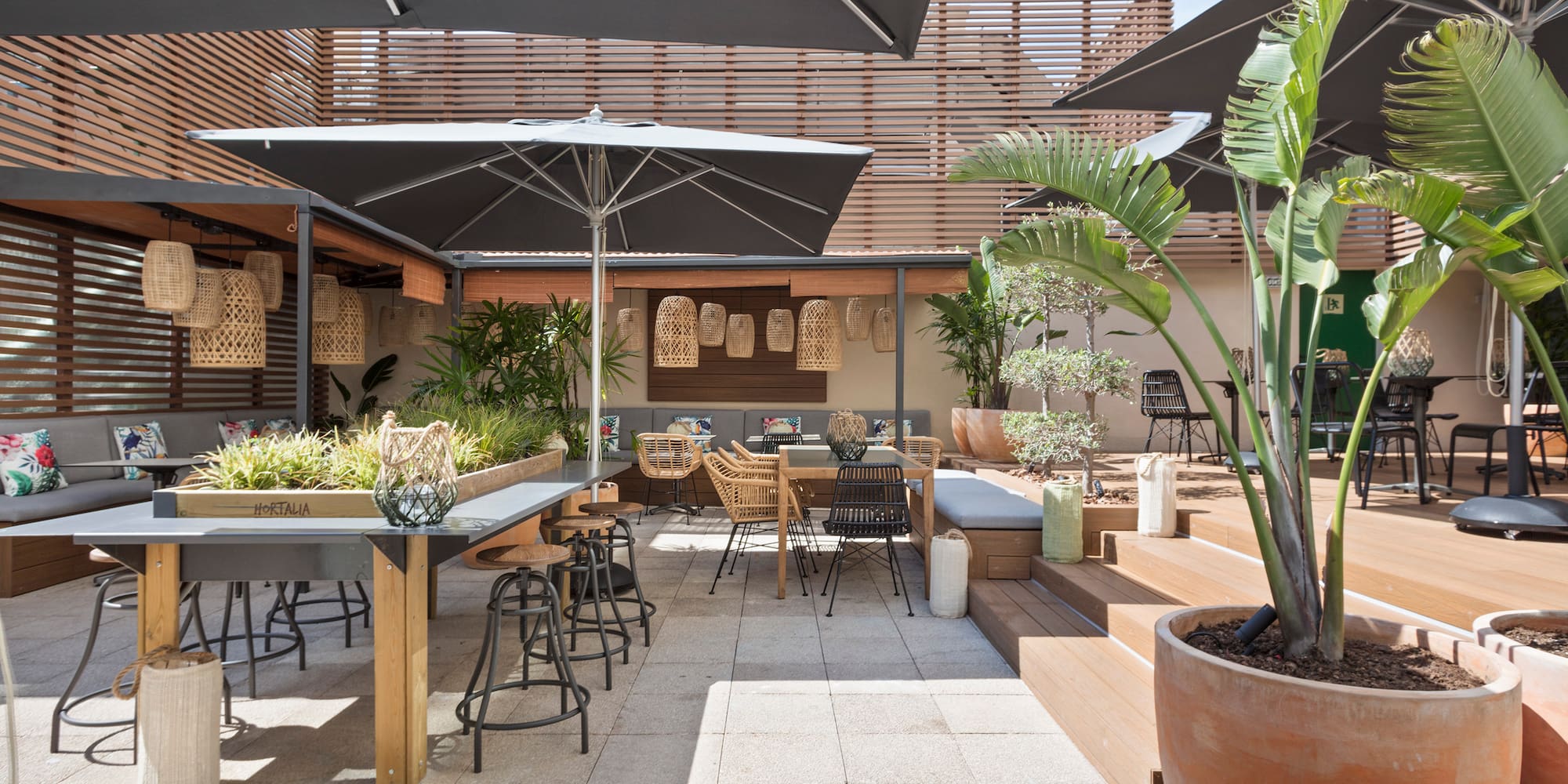 a patio with tables and chairs and umbrellas