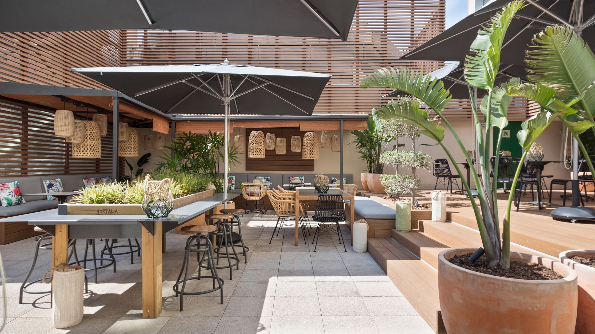 a patio with tables and chairs and umbrellas