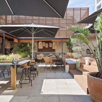 a patio with tables and chairs and umbrellas