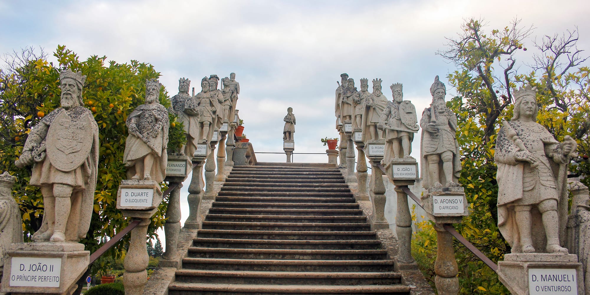 a stone staircase with statues on it
