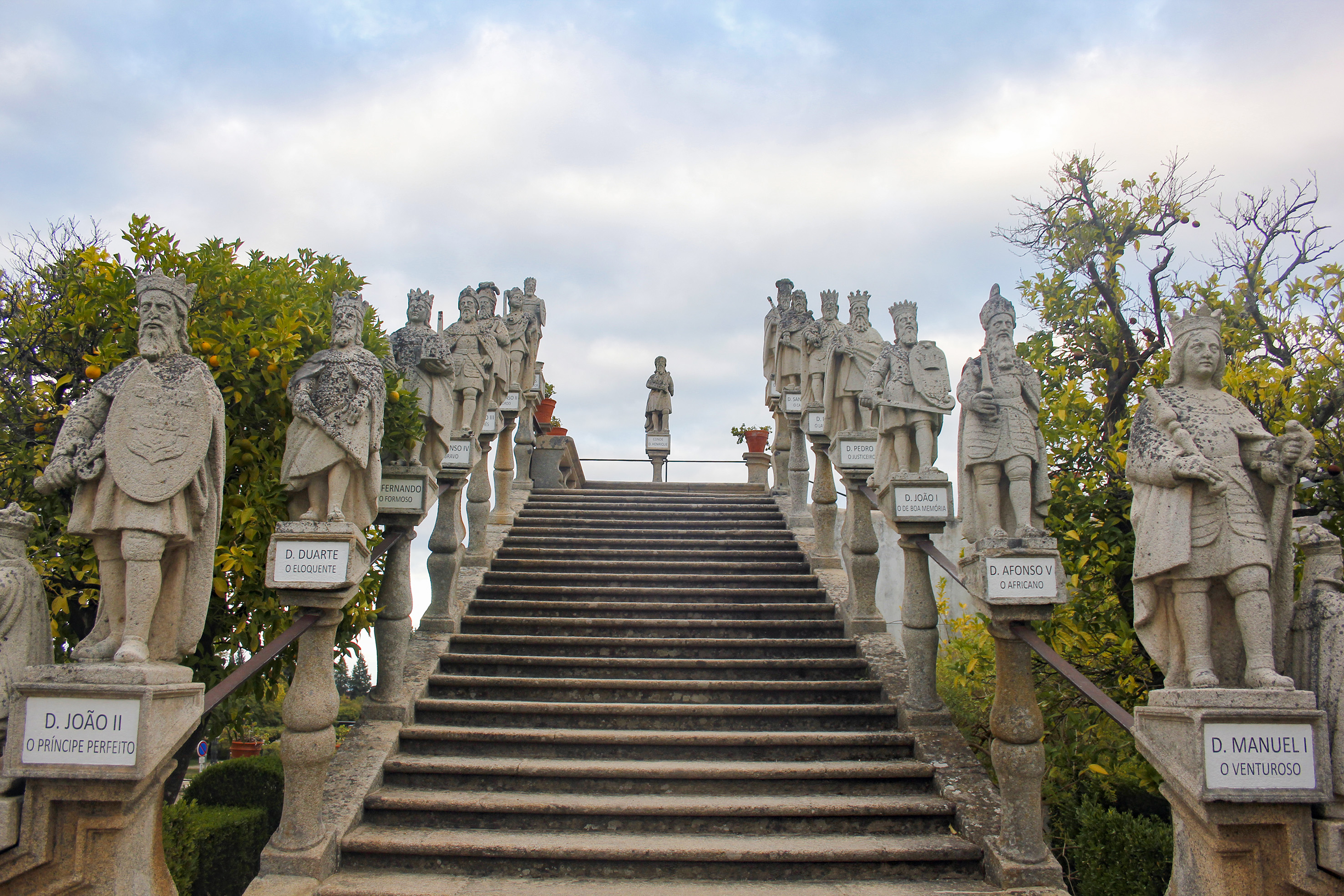 Historic stone staircase with statues of Portuguese kings.