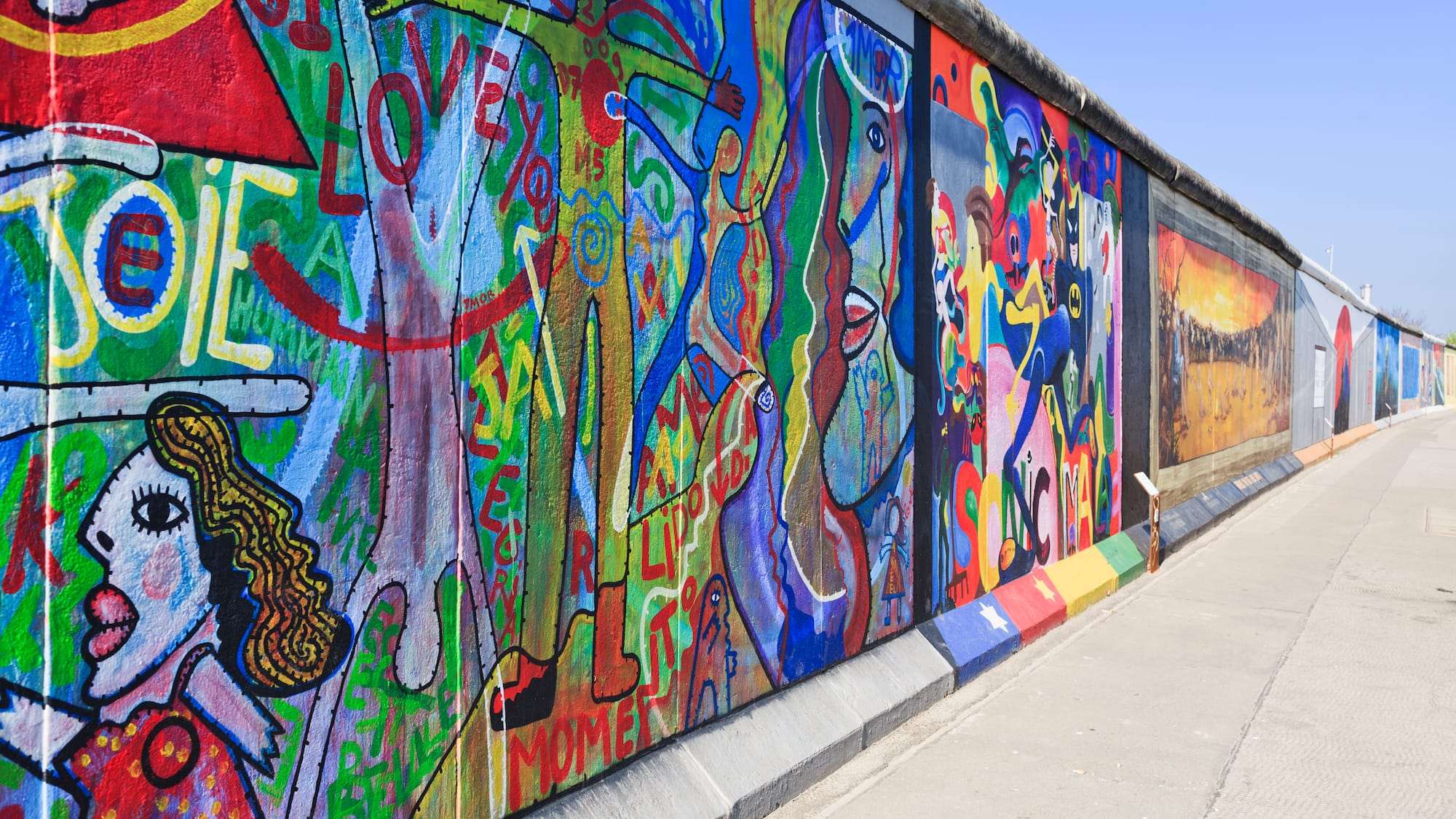 a wall with many different colors of art