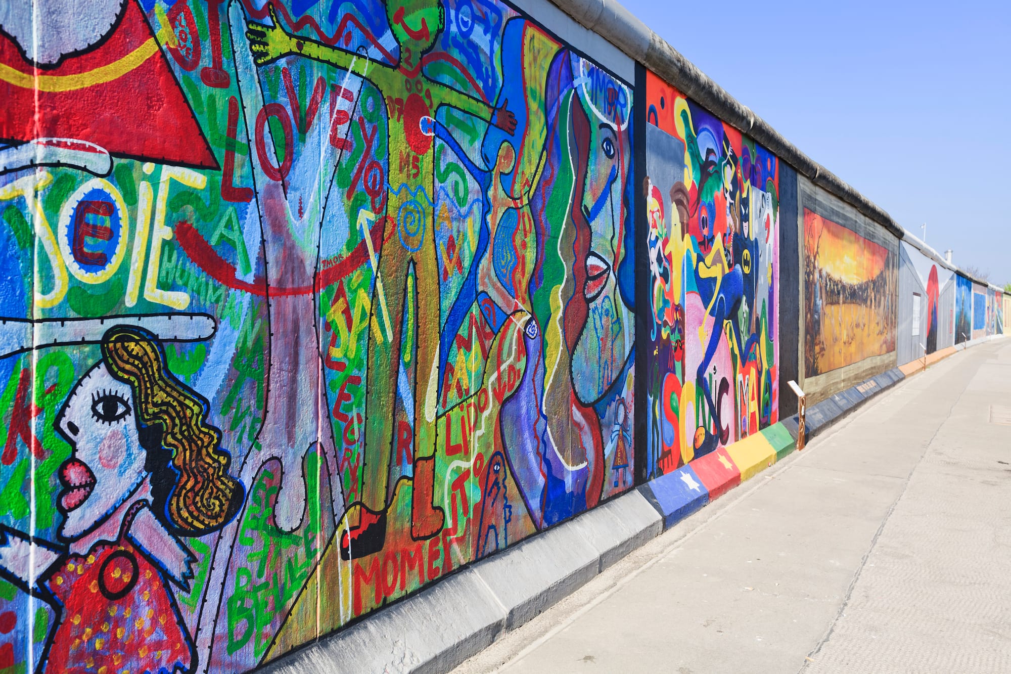 a wall with many different colors of art