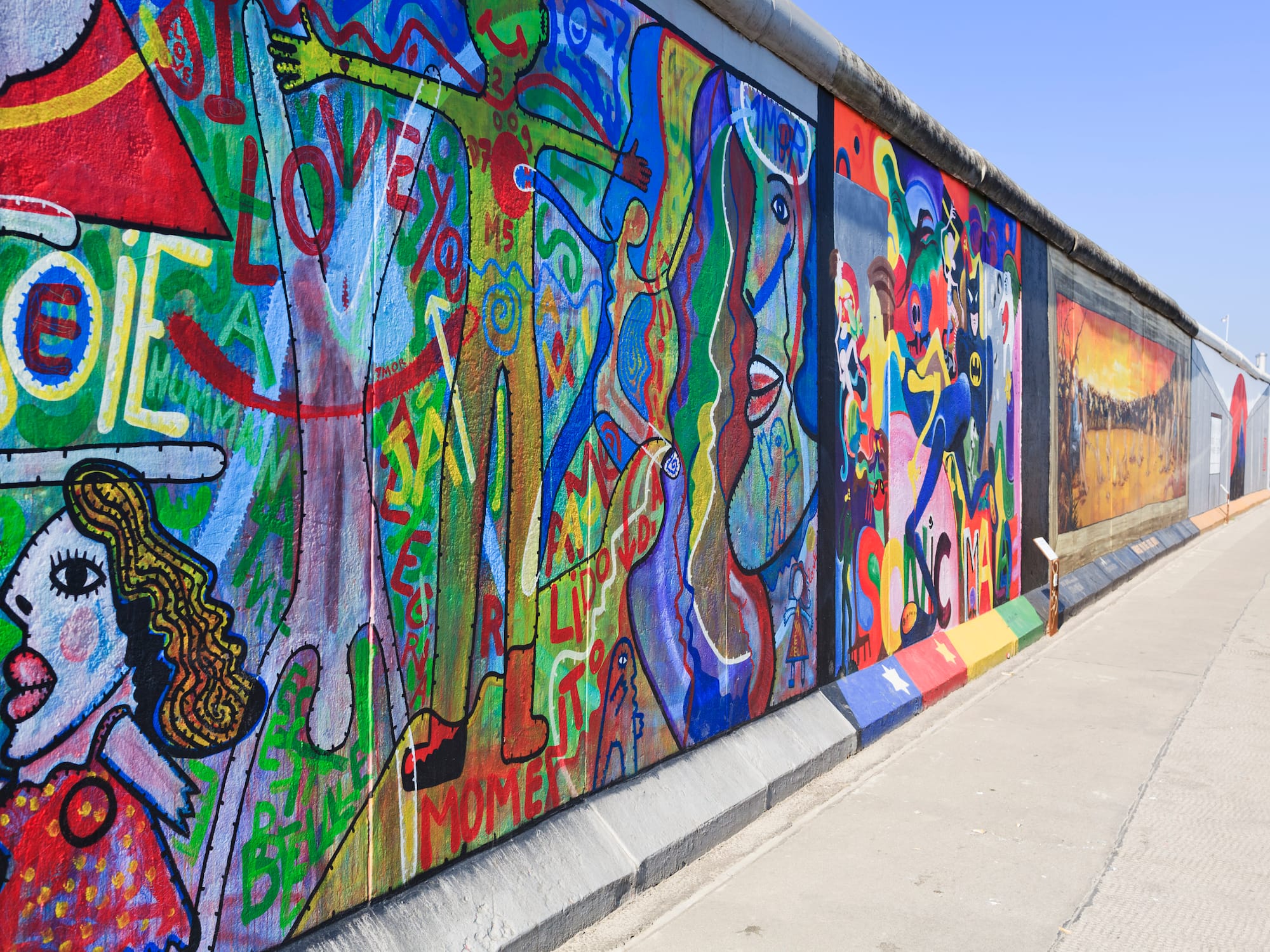 a wall with many different colors of art