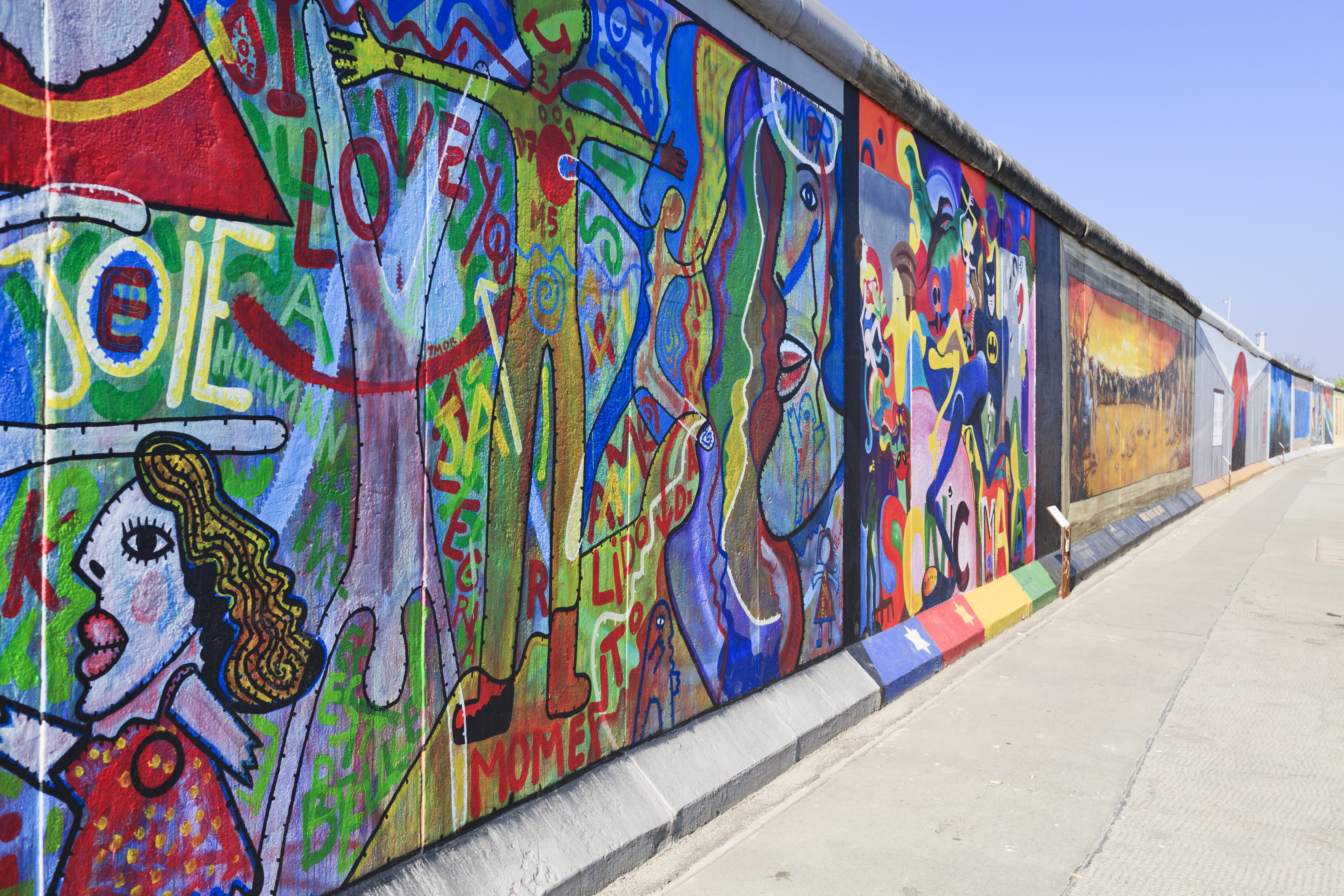 a wall with many different colors of art