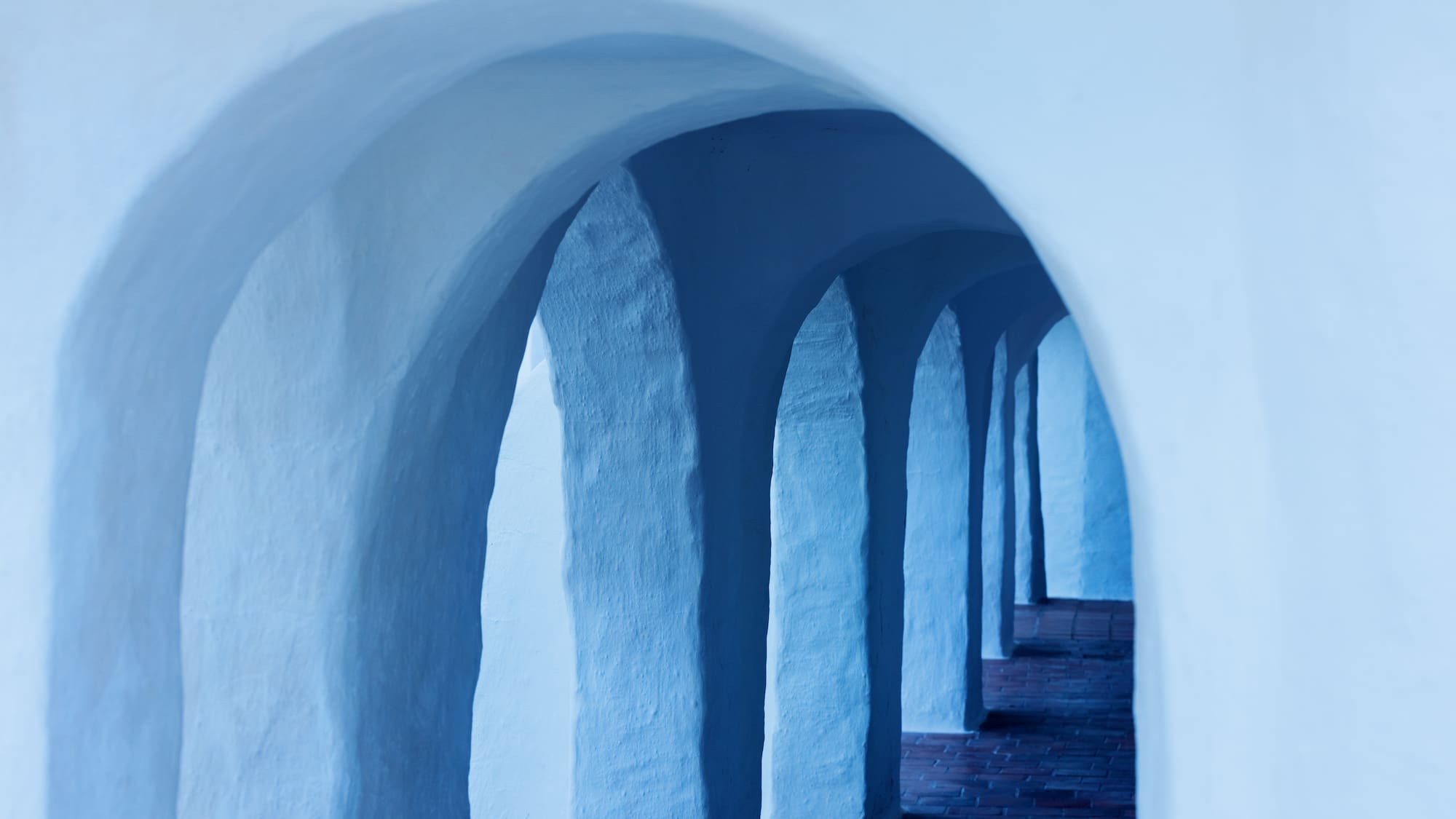 a white archways with blue arches