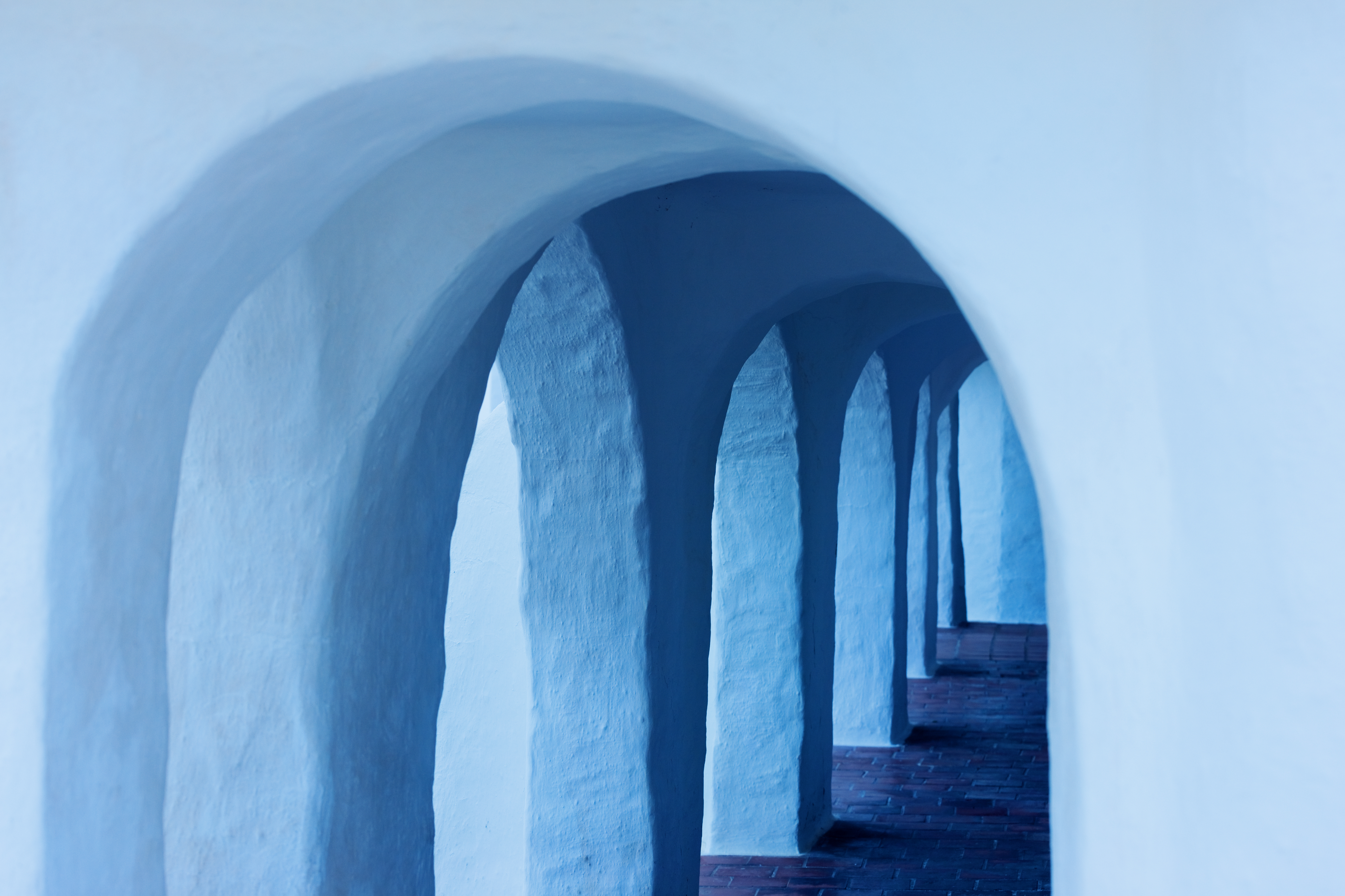 a white archways with blue arches