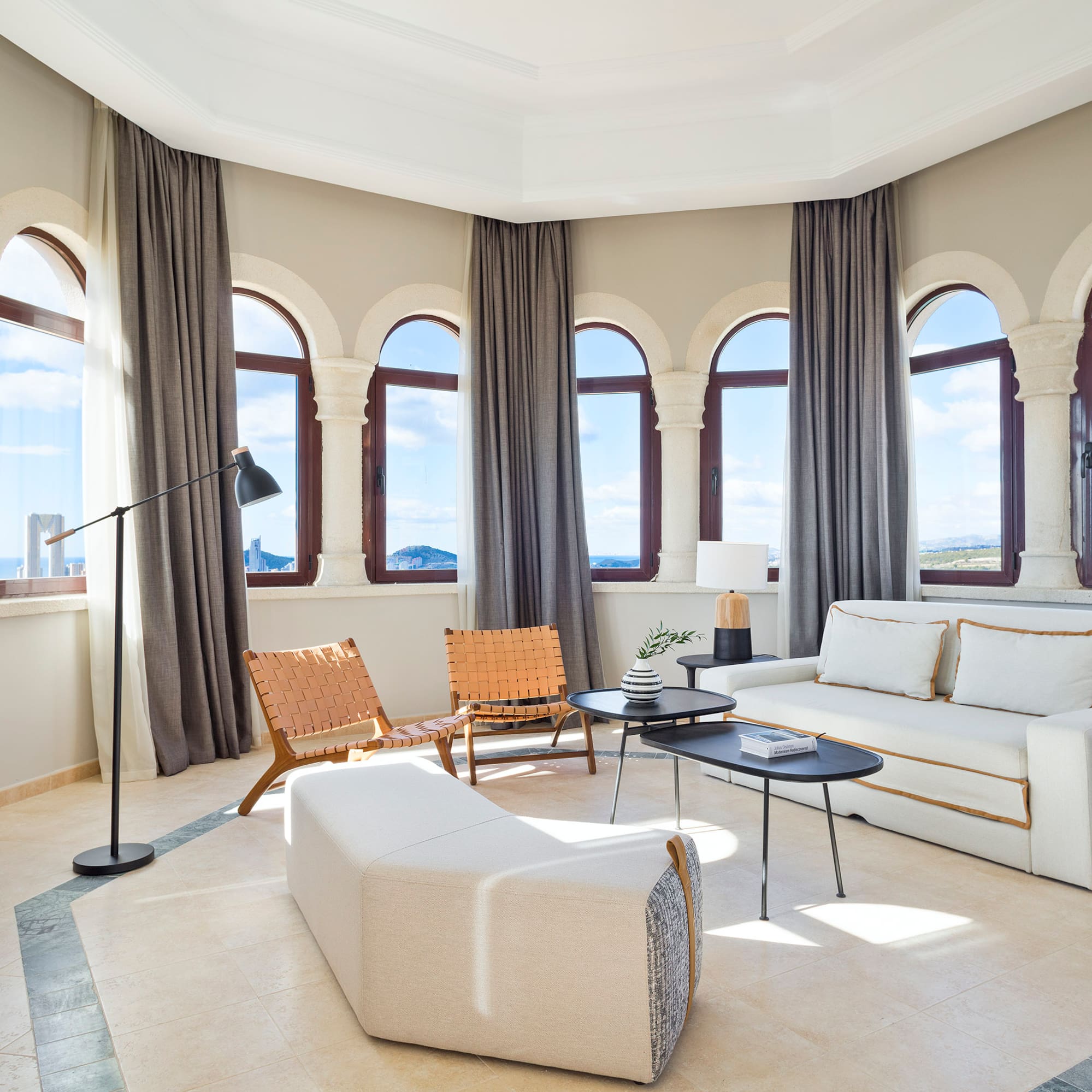 a room with a couch and chairs