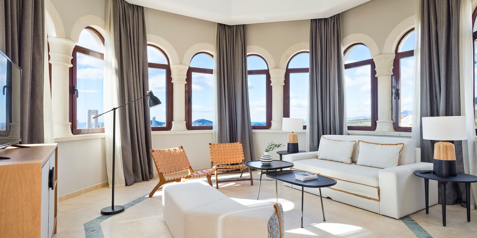 a room with a couch and chairs