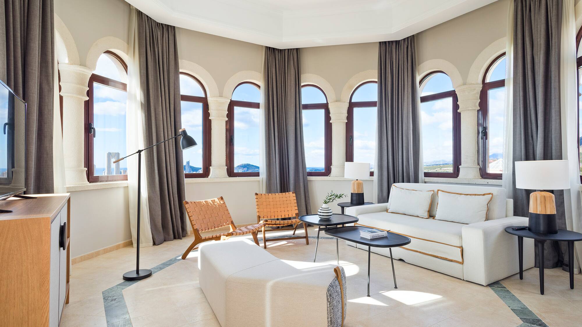 a room with a couch and chairs