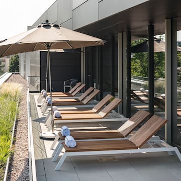 a row of chairs and umbrellas on a patio