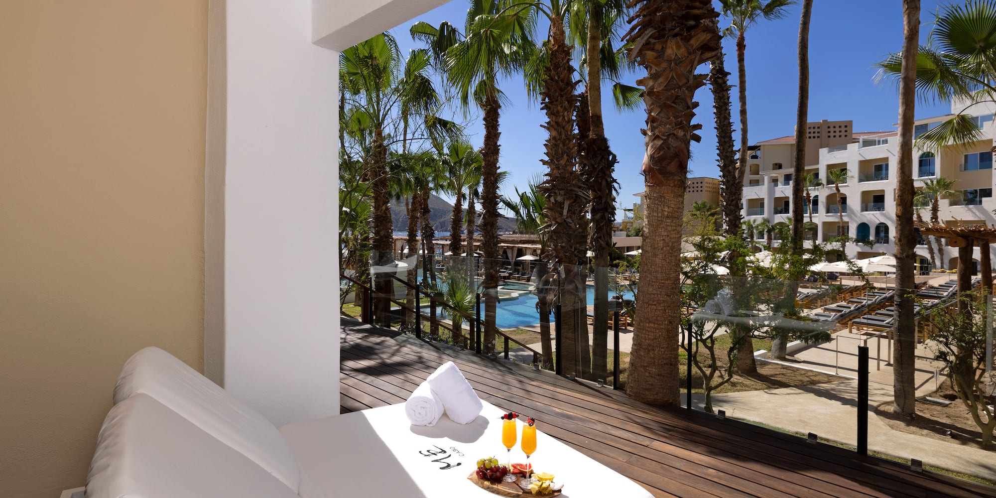 a bed with food on it outside of a balcony