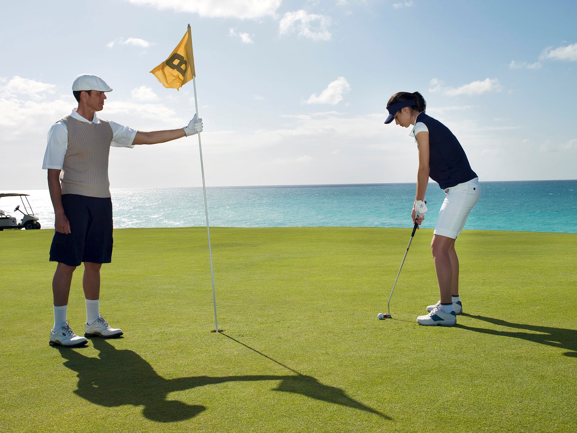a man and woman playing golf