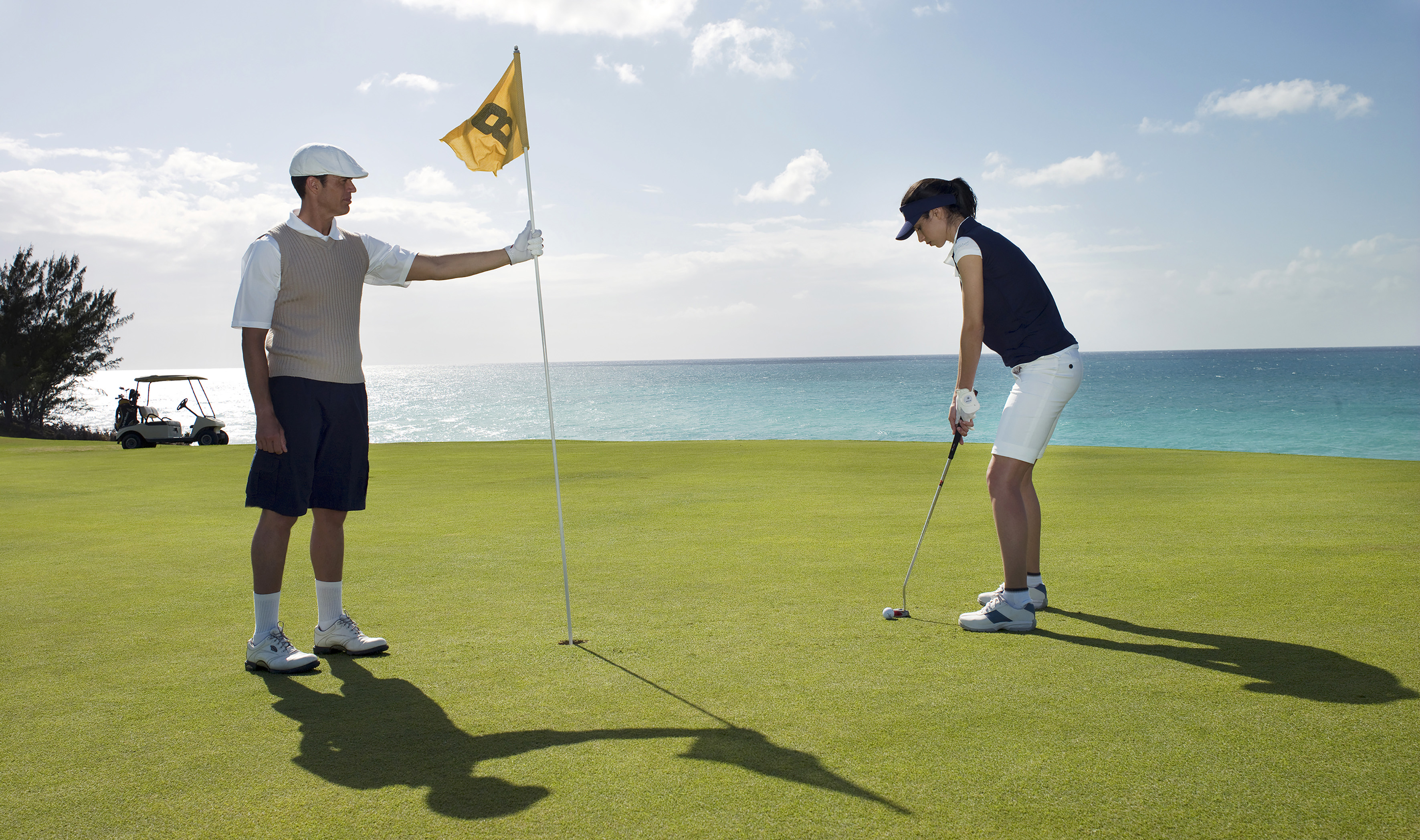 a man and woman playing golf