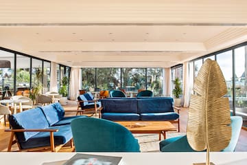 a room with blue couches and a table