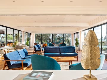 a room with blue couches and a table