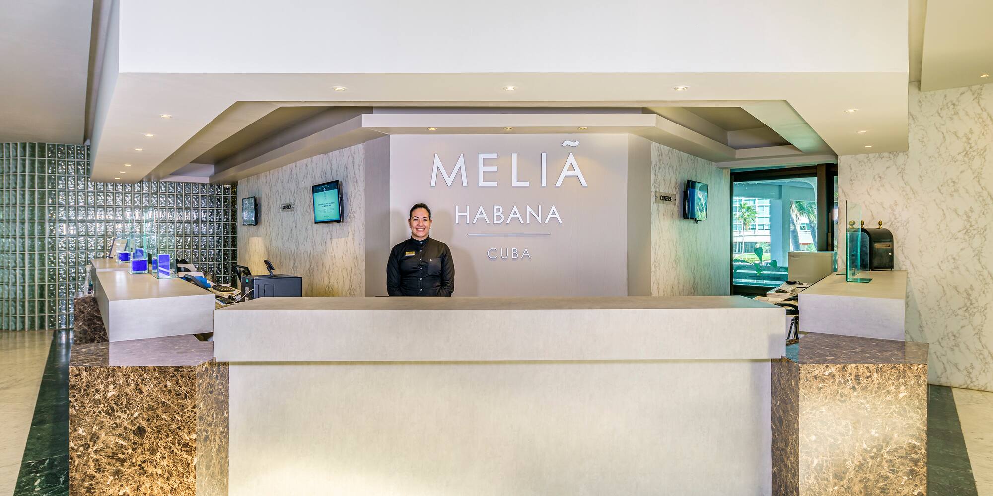 a woman standing at a reception desk