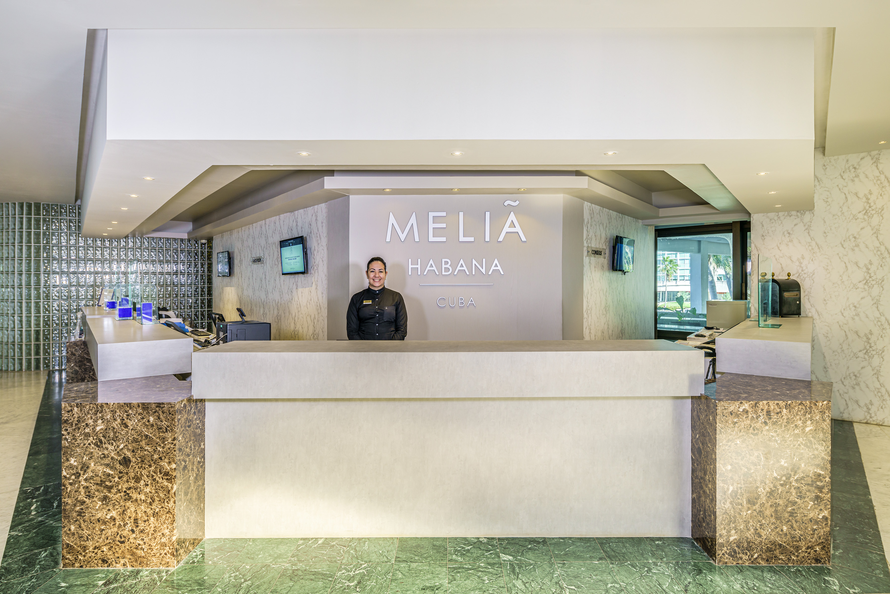 a woman standing at a reception desk