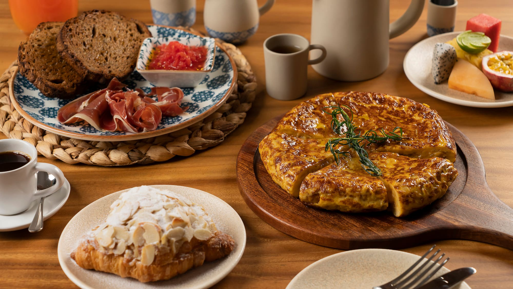 a table with plates of food and utensils