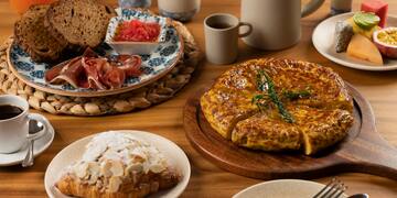 a table with plates of food and utensils