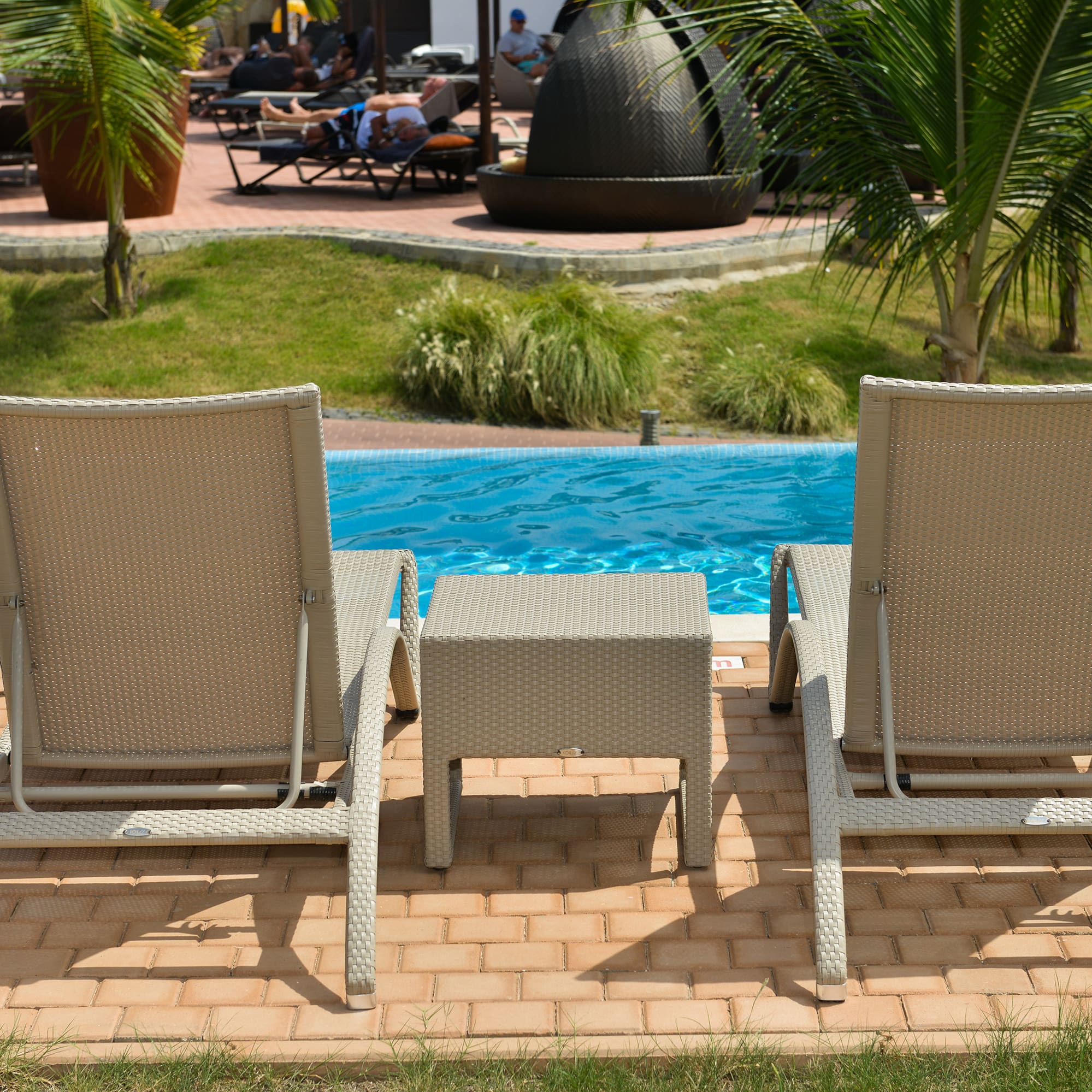 a group of chairs next to a pool