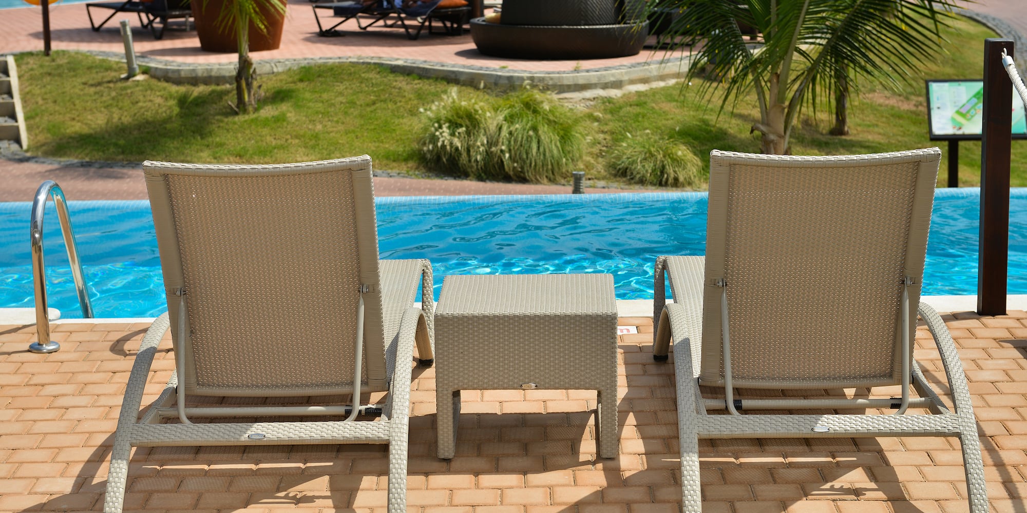 a group of chairs next to a pool