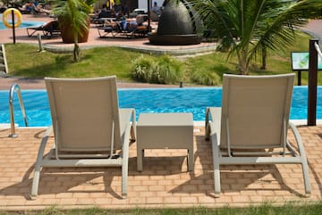 a group of chairs next to a pool