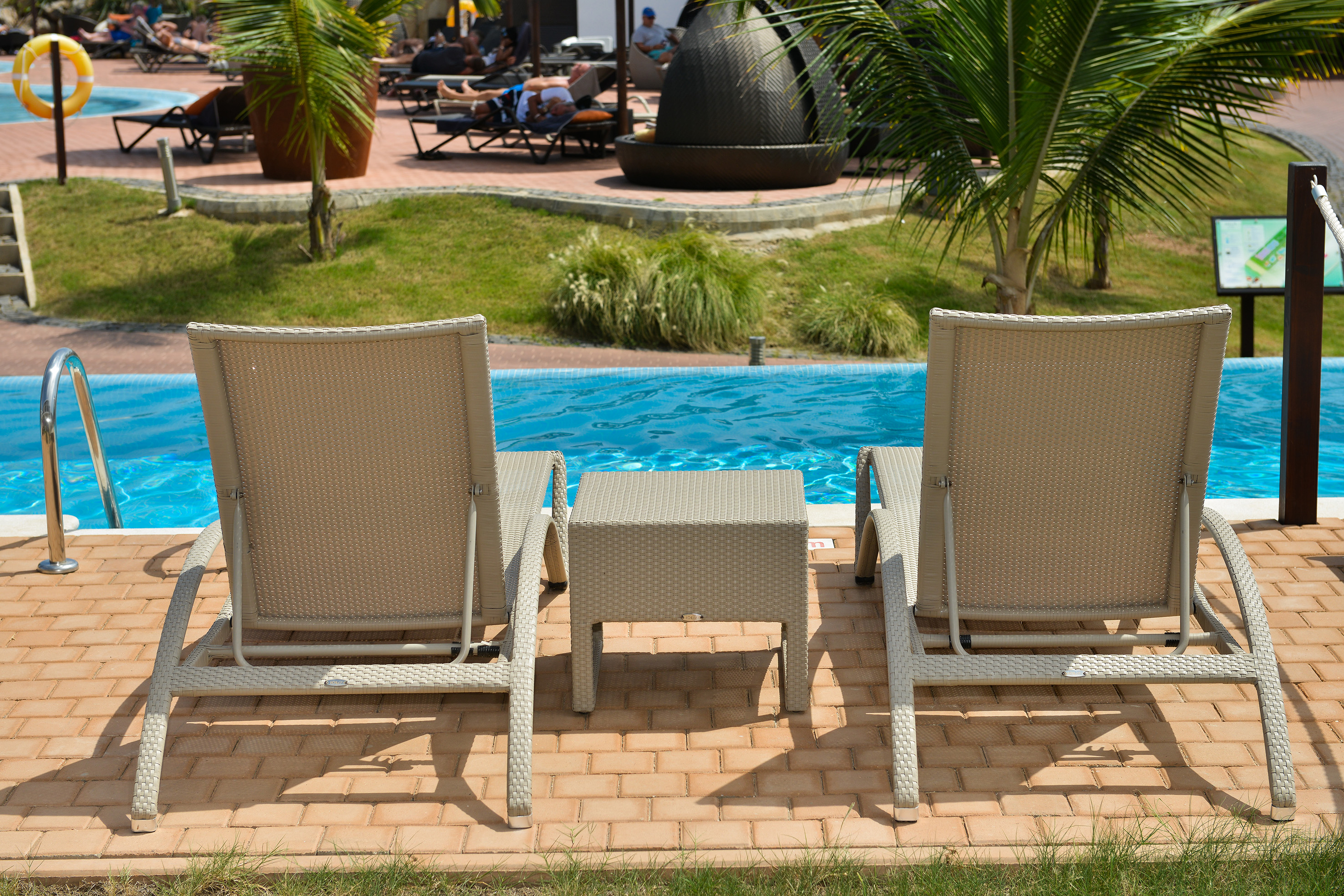a group of chairs next to a pool