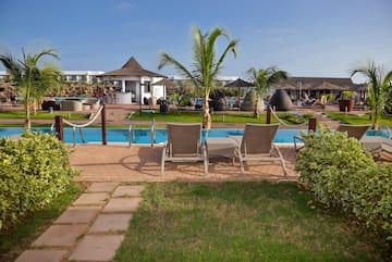 a pool with chairs and palm trees