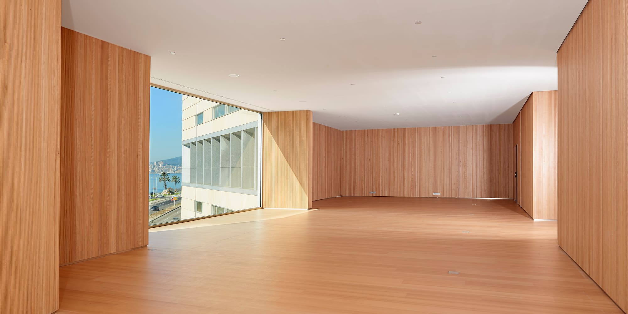 a large room with wood walls and a large window