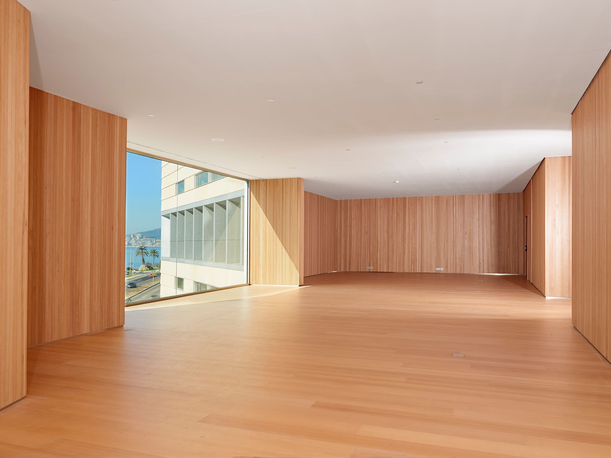 a large room with wood walls and a large window