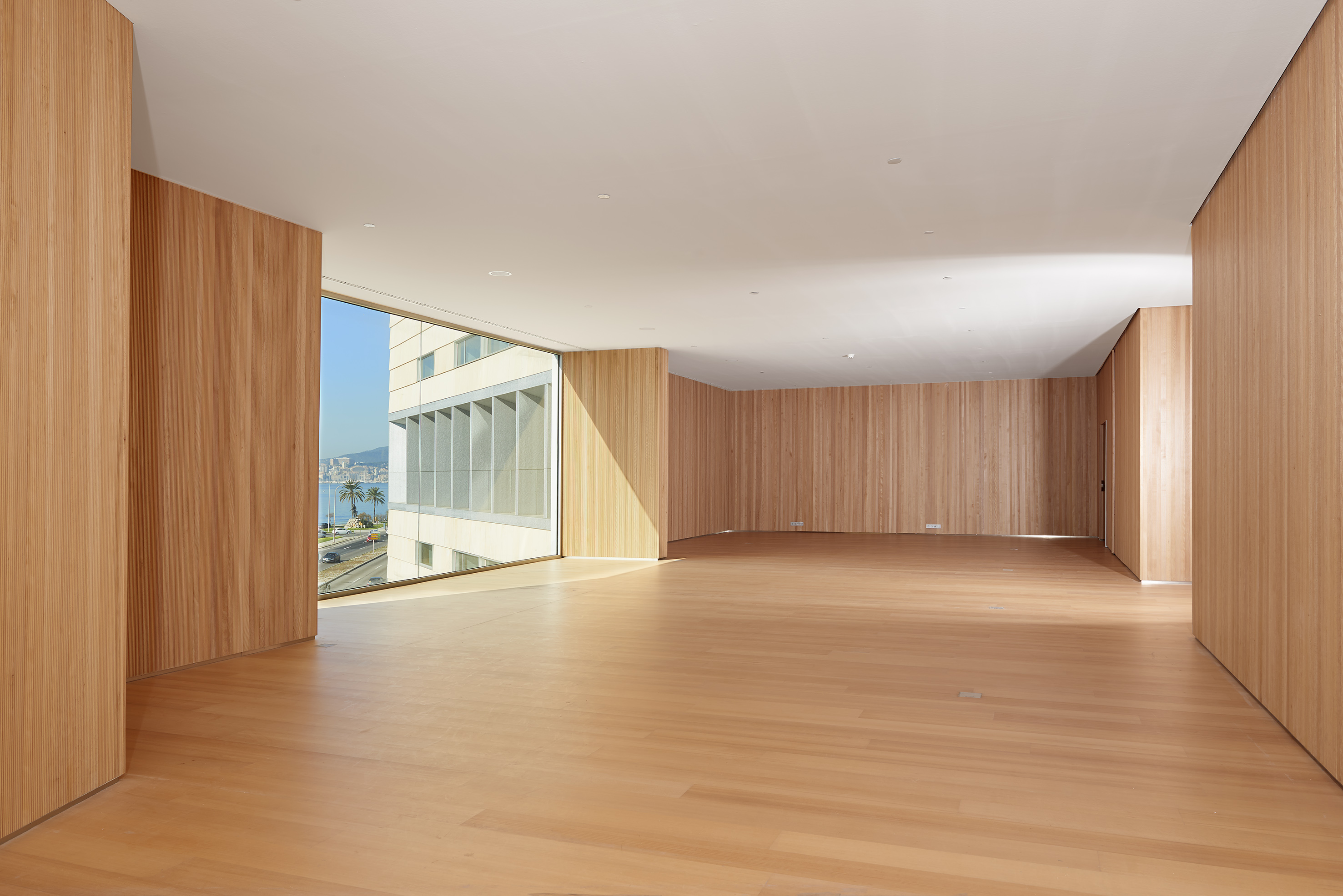 a large room with wood walls and a large window