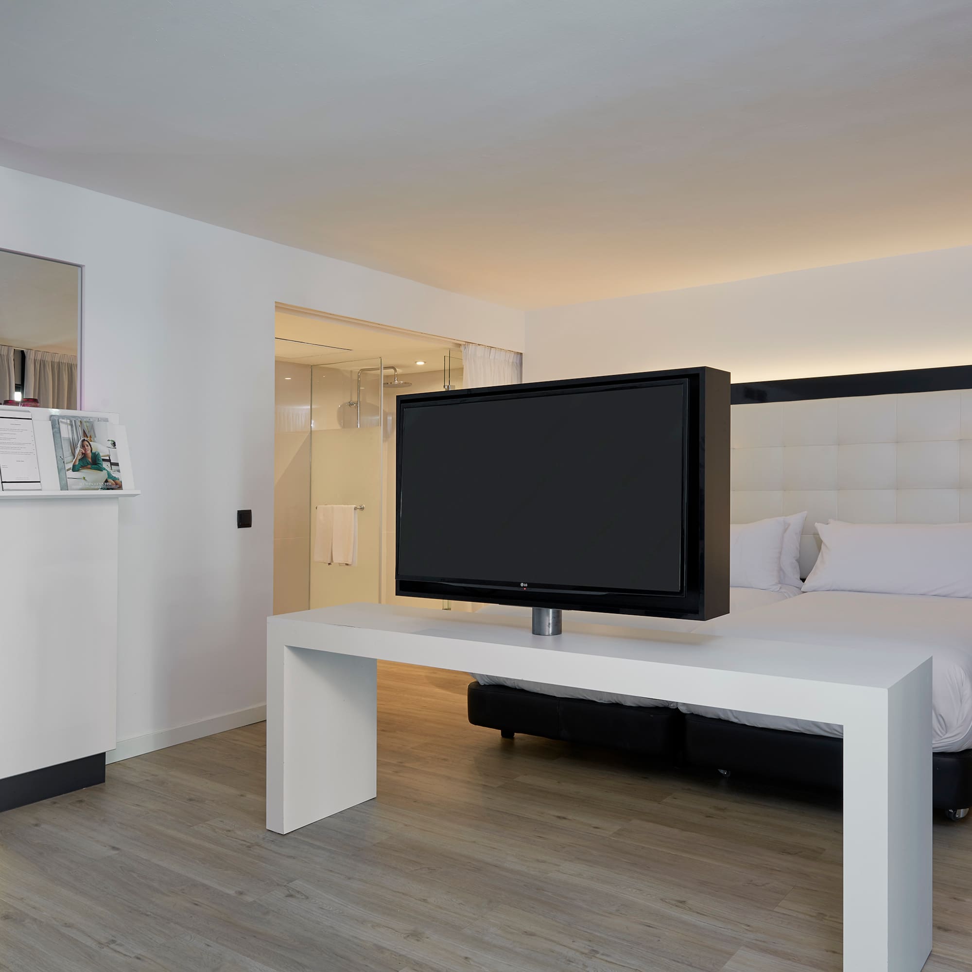 a tv on a table in a hotel room