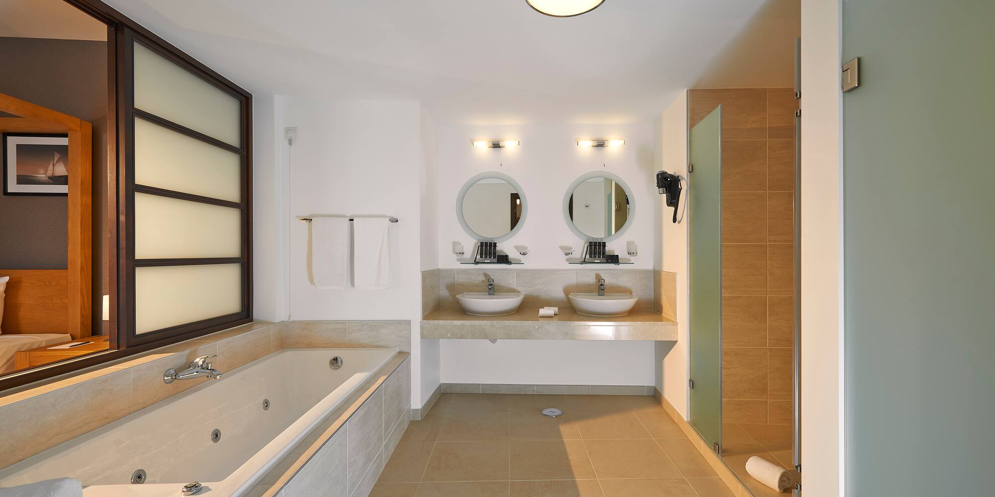 a bathroom with a tub and sinks