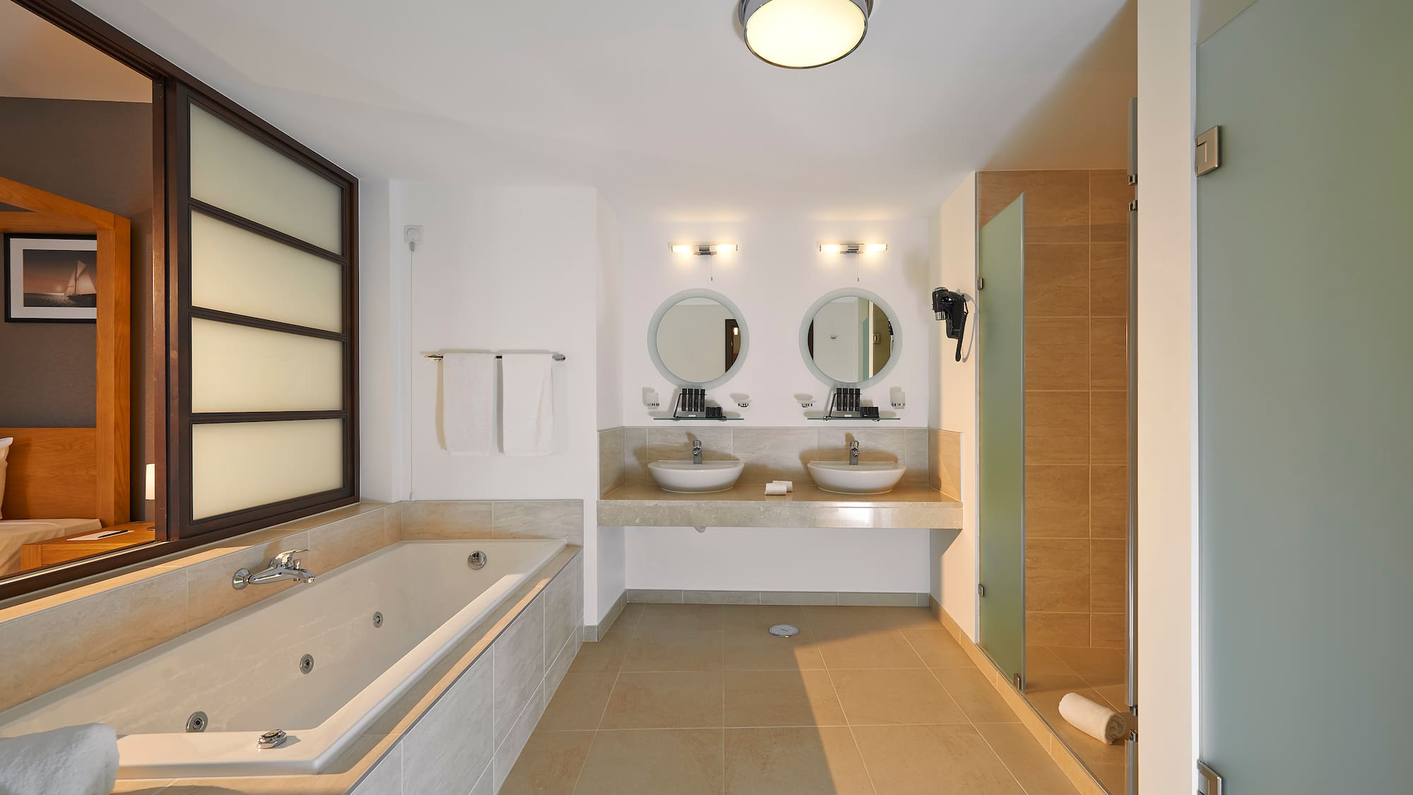 a bathroom with a tub and sinks