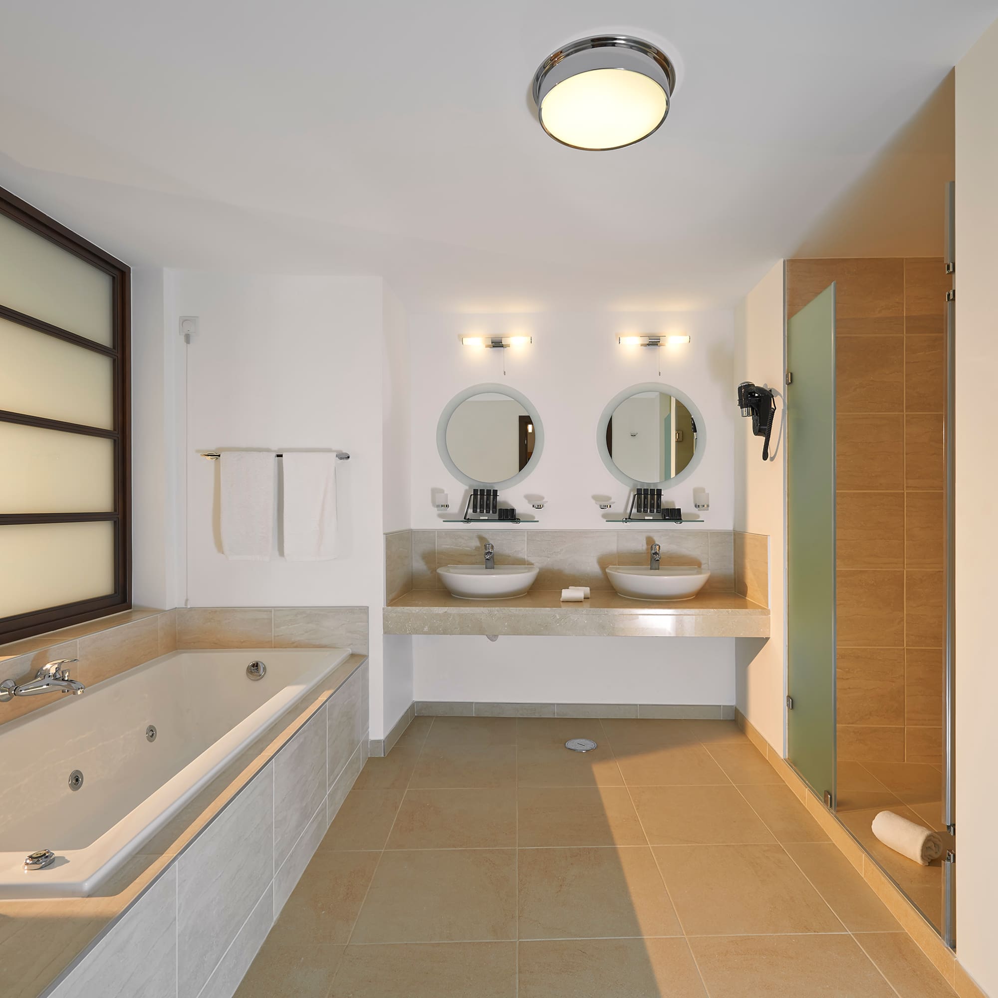 a bathroom with a tub and sinks