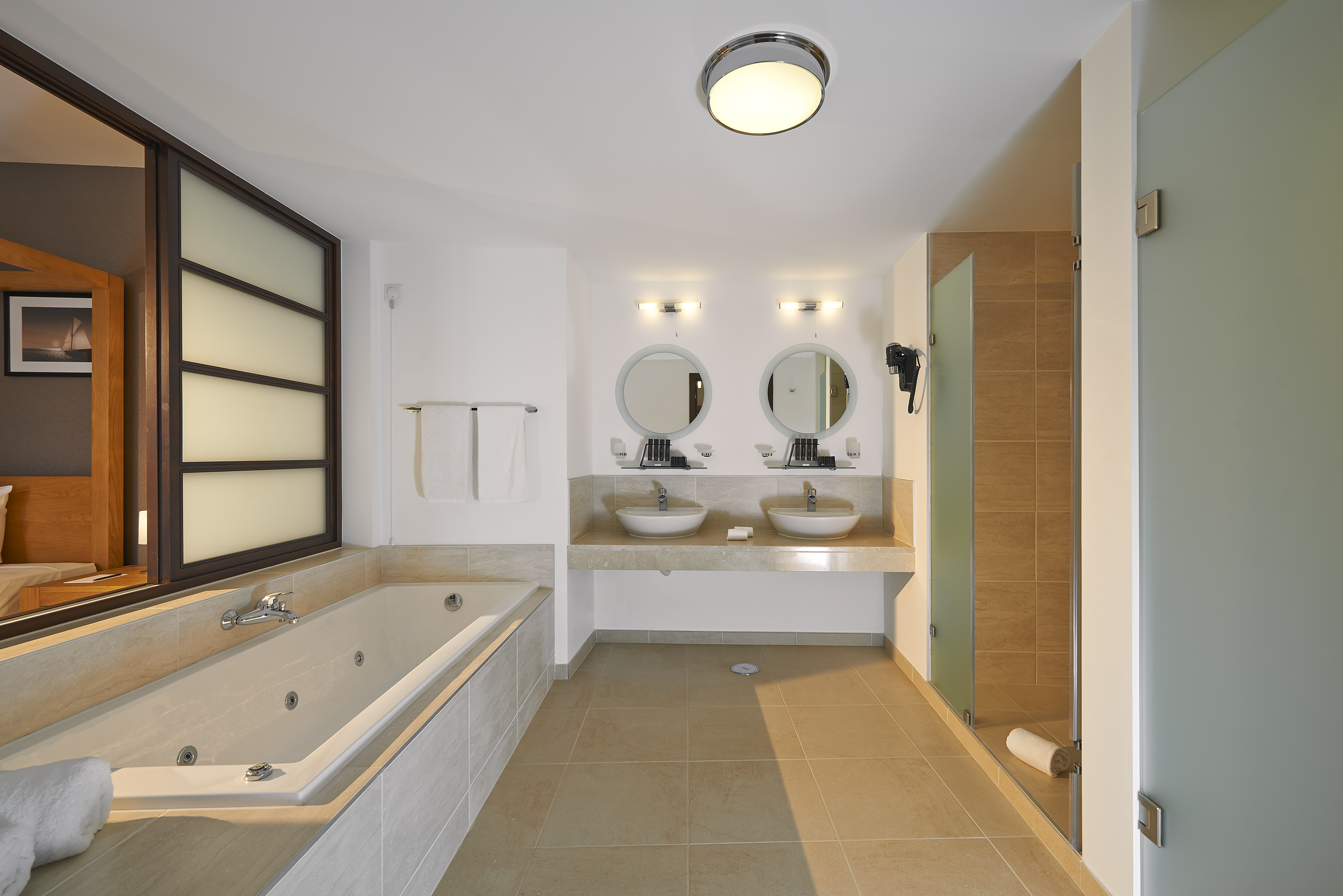 a bathroom with a tub and sinks