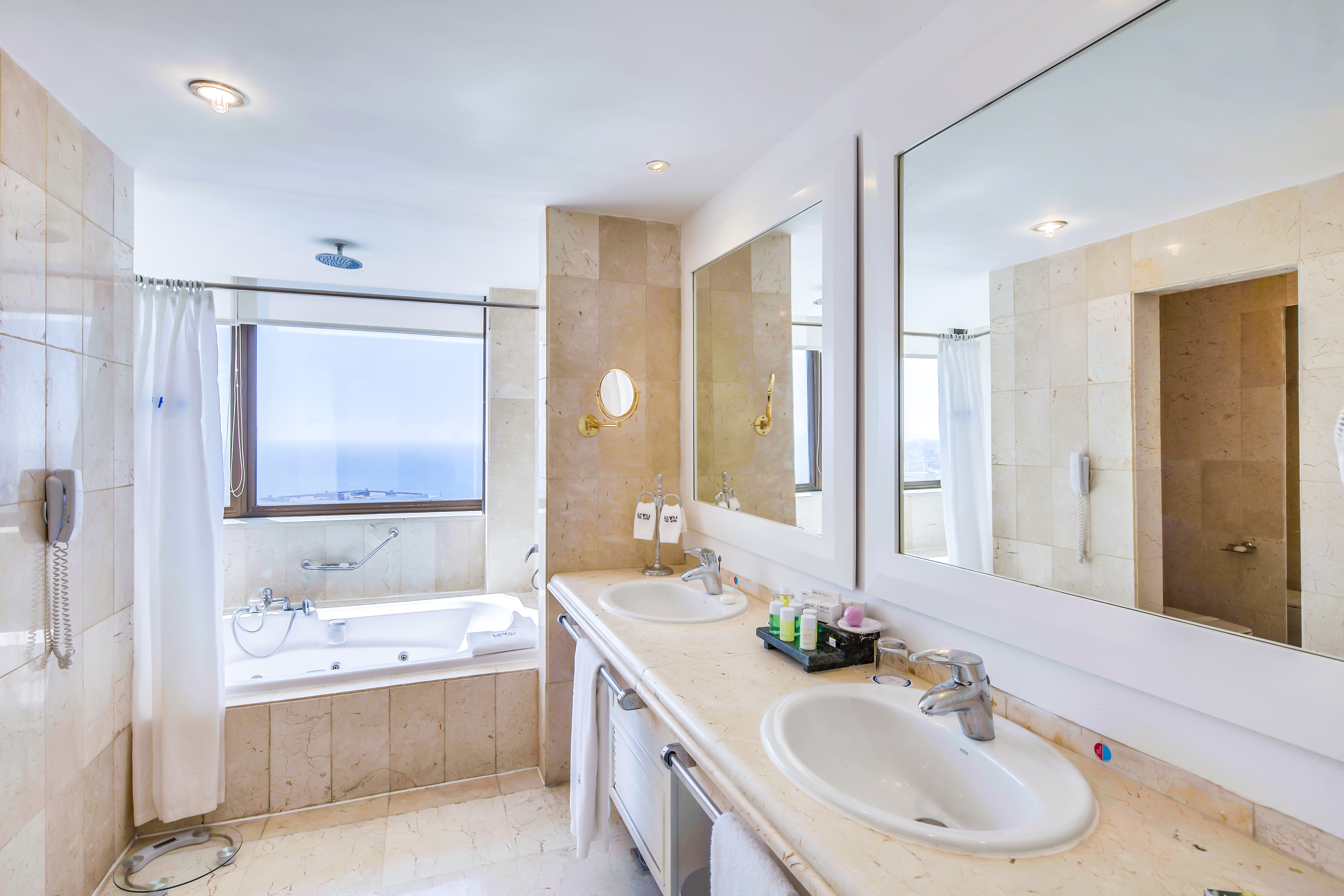 a bathroom with a tub and sinks